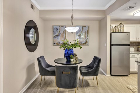 A modern dining room with a round table and chairs.