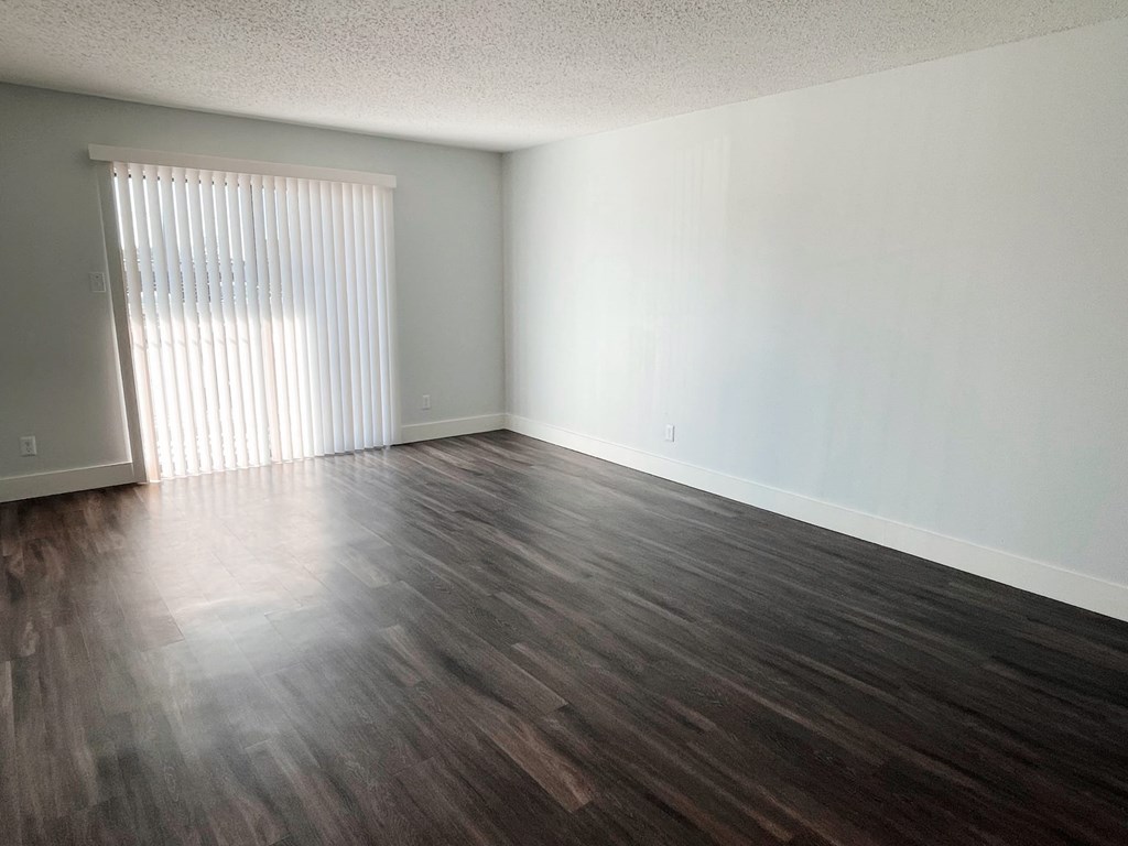 an empty living room with wood floors and a window at Northchase, Texas, 78753