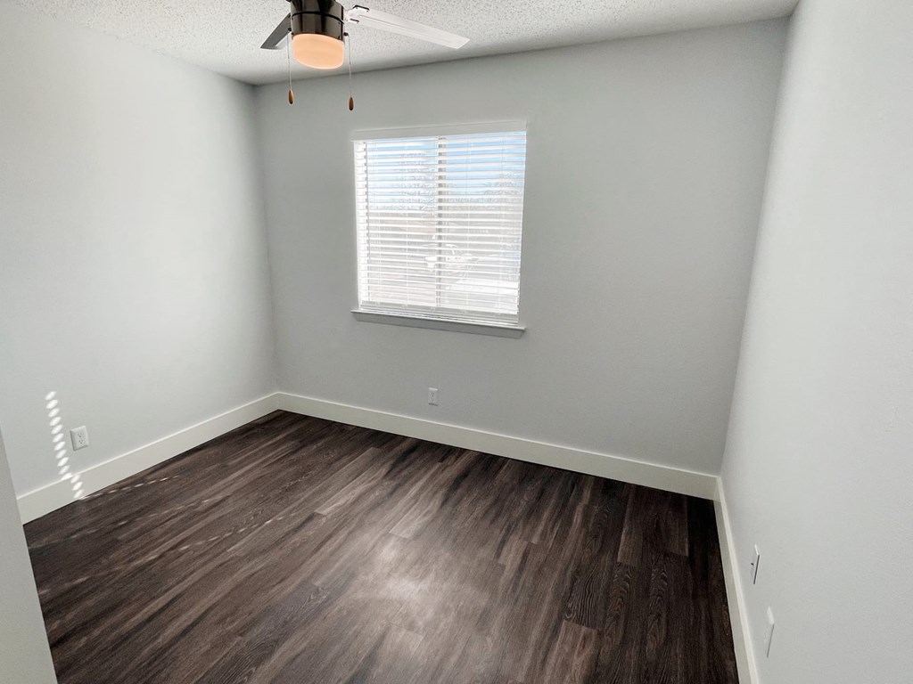 an empty room with wood flooring and a window at Northchase,Texas