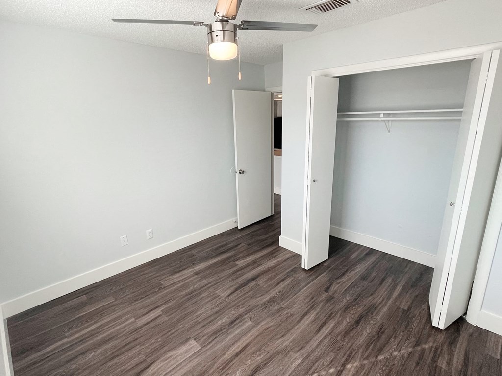 an empty bedroom with a closet and a ceiling fan at Northchase, Austin