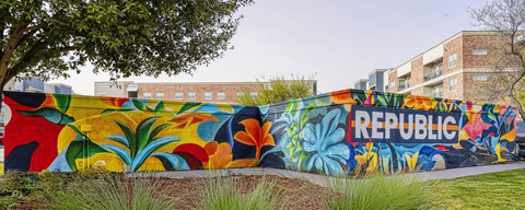 A wall with a mural of the word "REPUBLIC" painted on it.