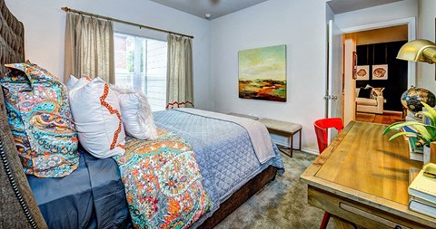 a bedroom with a bed and a desk at Villa Espada Apartments, San Antonio