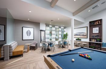 a resident clubhouse with a pool table and seating