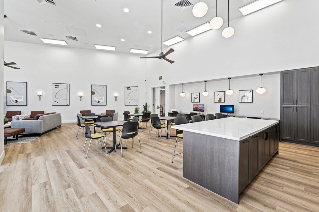 A modern office space with a reception desk and multiple seating arrangements.
