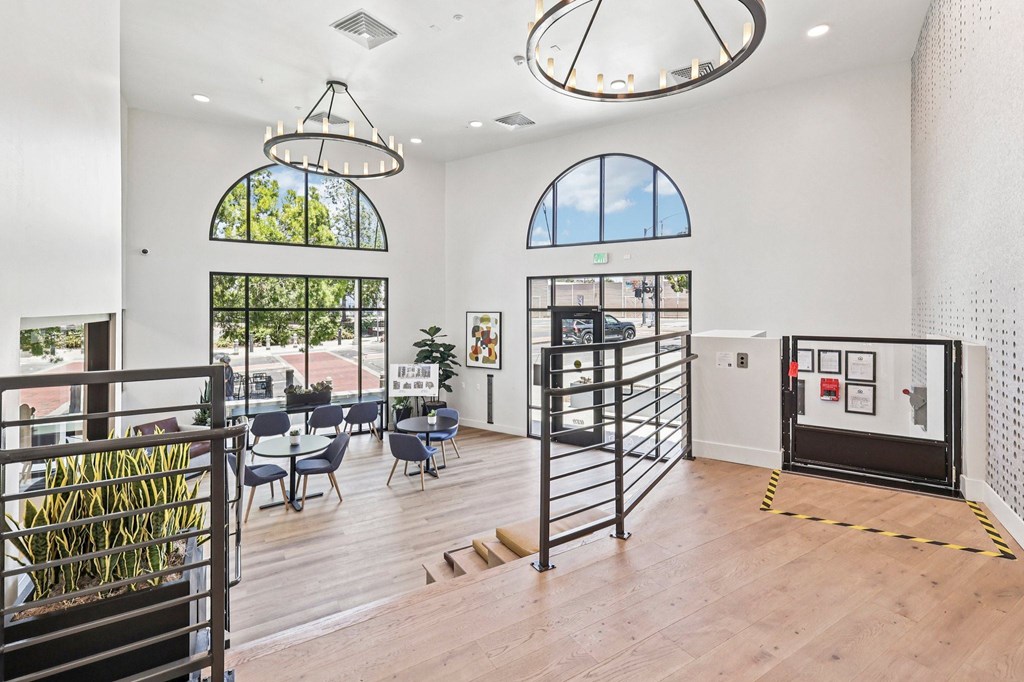 A room with a black gate and a wooden floor.