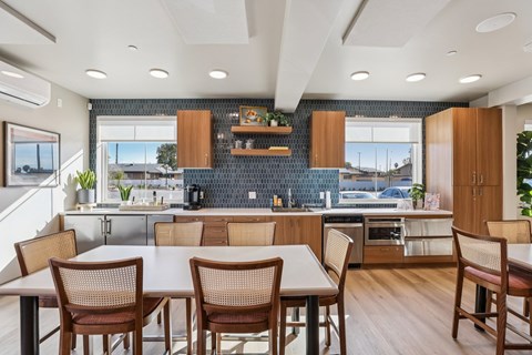 A modern kitchen with a dining table and chairs.