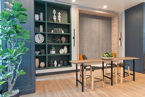 A dining room with a wooden table and chairs.