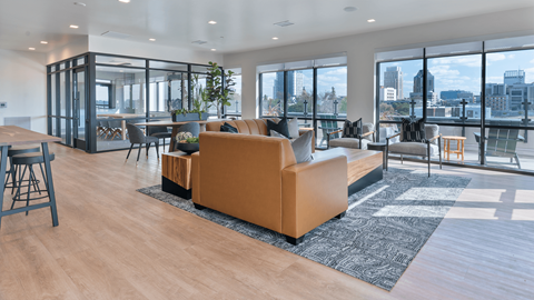A modern living room with a large sofa and a view of the city.