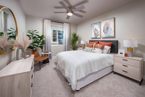 an open bedroom with a bed and a ceiling fan