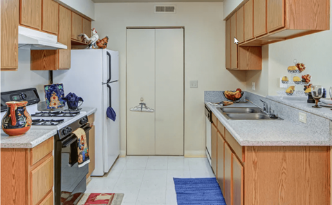 A kitchen with wooden cabinets and a white refrigerator.