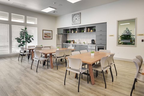 A modern dining room with a large table and chairs.