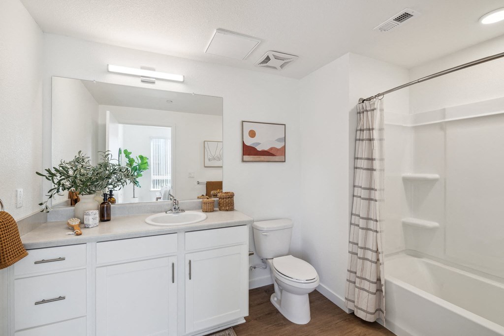 a white bathroom with a toilet and a sink