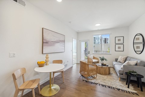 A living room with a white table and chairs.