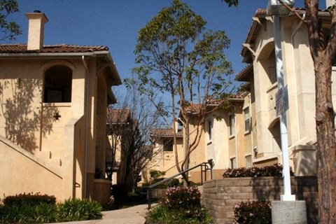 A row of houses with a clear blue sky above them.
