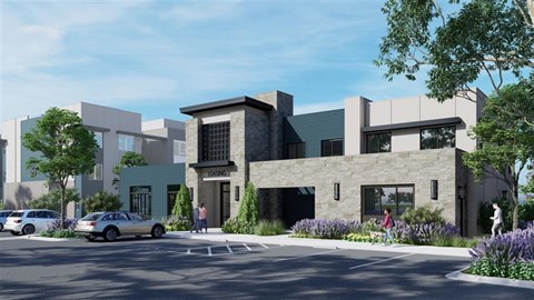 A modern building with a parking lot in front.
