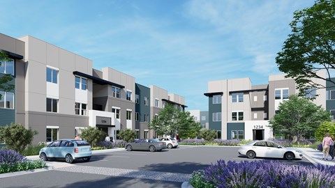 A modern apartment complex with cars parked in front and people walking on the sidewalks.