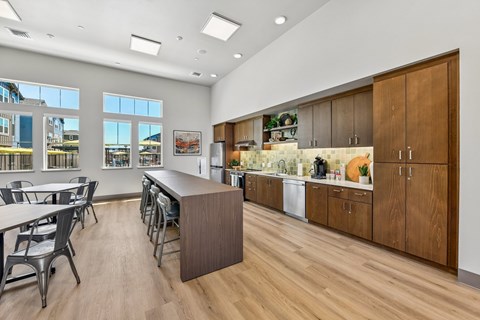 A kitchen with wooden cabinets and a long island.