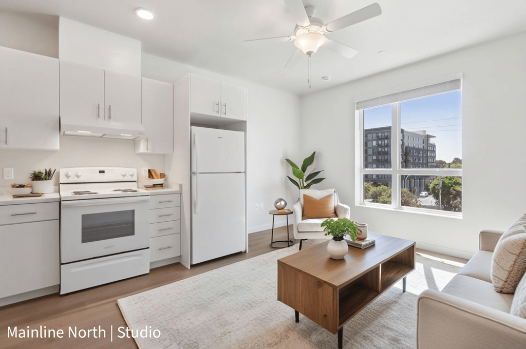 A well-lit, modern kitchen and living room with a view of the city.