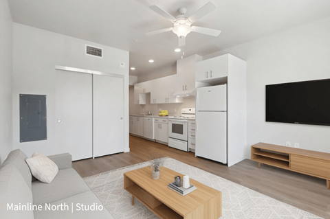 A modern living room with a grey sofa and a wooden coffee table.