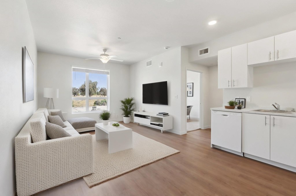 A modern living room with a large couch and a flat screen TV.