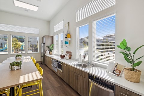A kitchen with a table and chairs and a sink.