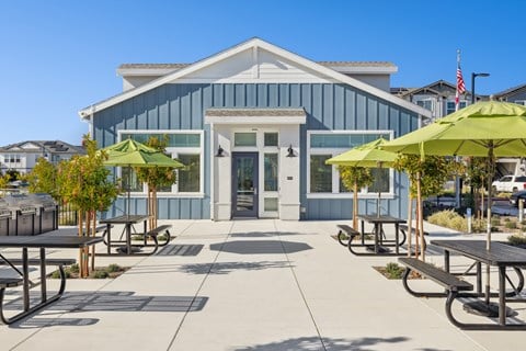 Exterior of the clubhouse with picnic tables