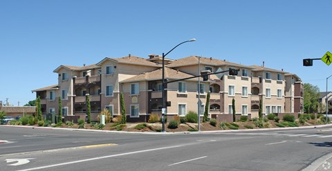 Apartment building with a yellow pedestrian crossing sign in front of it.