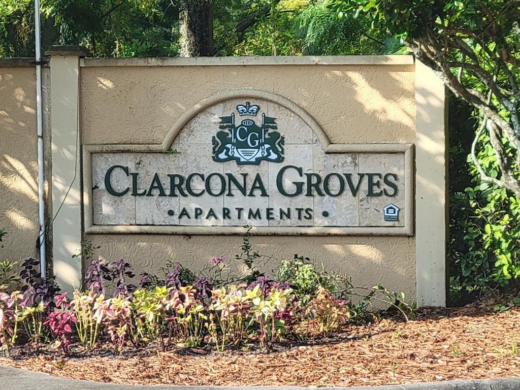 a sign in front of some flowers