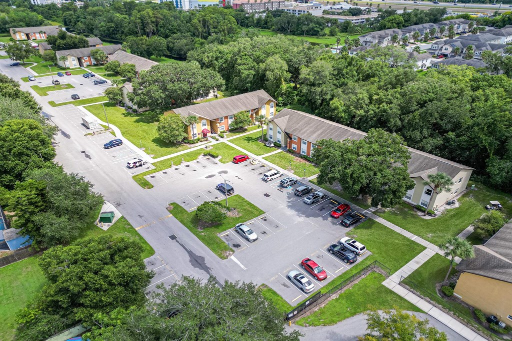 an aerial view of a parking lot with cars and a church