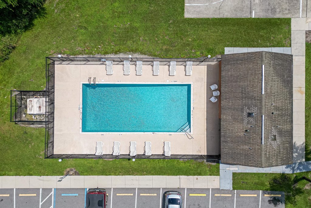 a birds eye view of a swimming pool on the grass