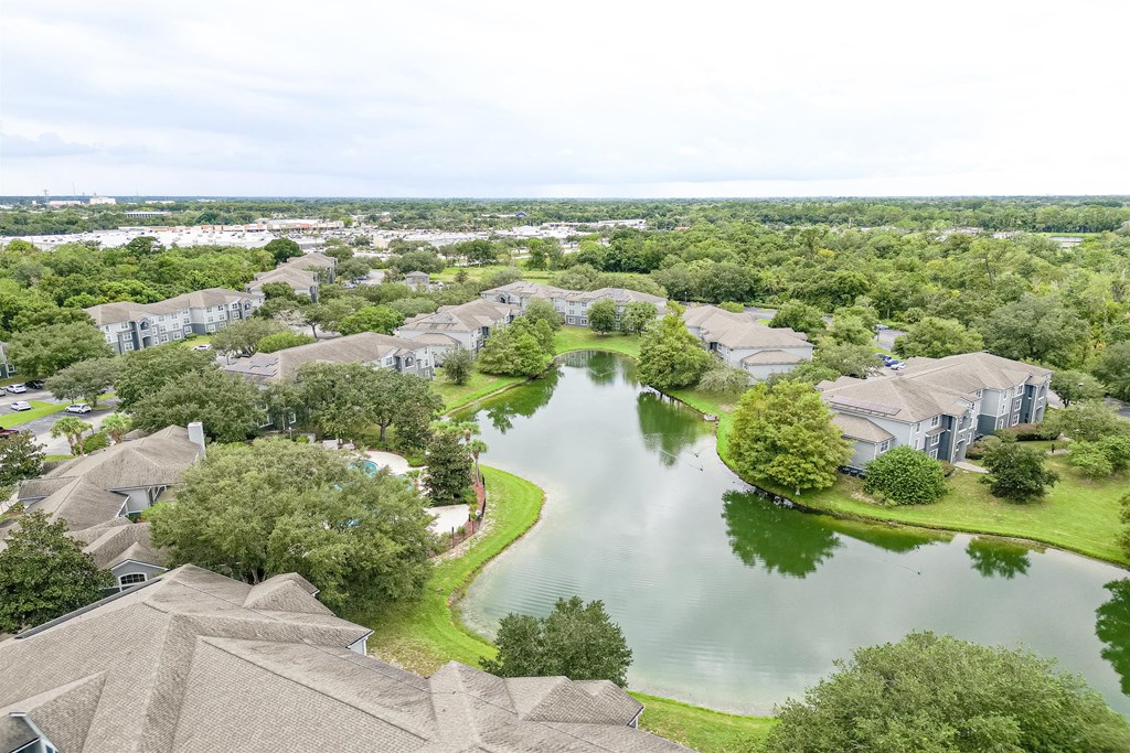 an aerial view of a neighborhood with a lake surrounded by houses