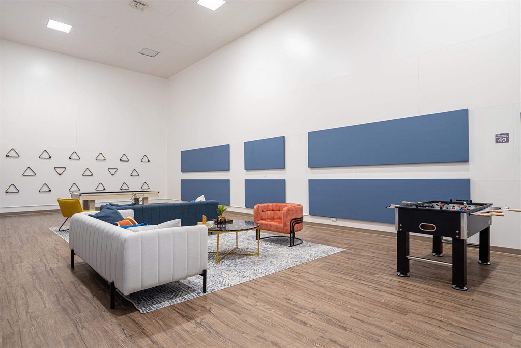 a living room with furniture and a pool table