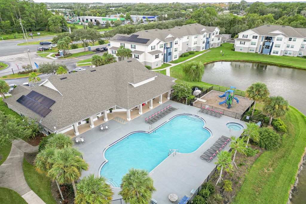 an aerial view of the resort style swimming pool and poolside pavilion of the