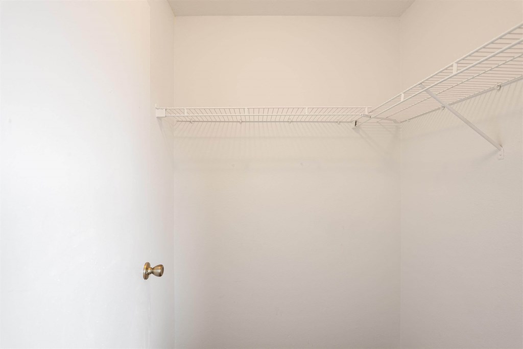 a white bathroom with a white door and a white closet