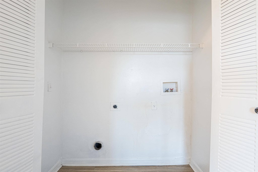 an empty room with white walls and a white door