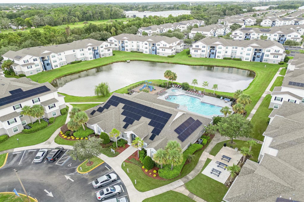 an aerial view of an apartment complex and a swimming pool