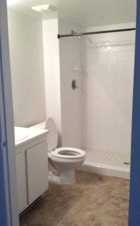 a bathroom with a toilet and a shower