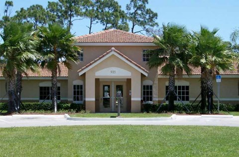 a building with palm trees in front of it
