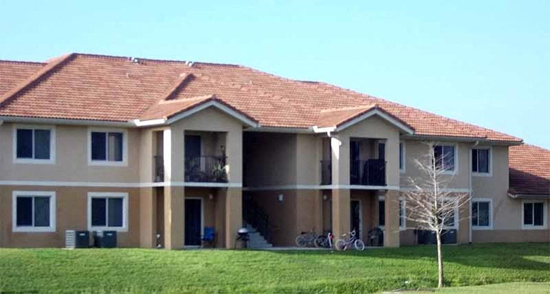 a large house with a red roof and bicycles parked in front of it