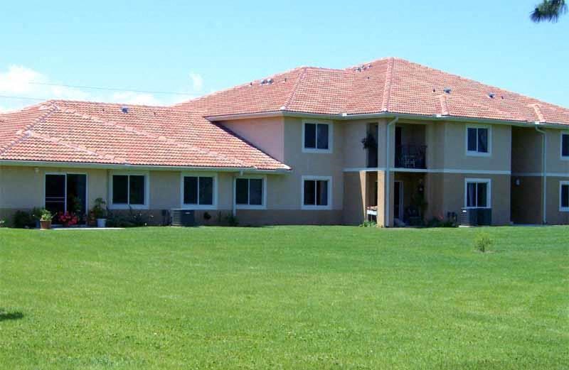 a large house with a green lawn in front of it