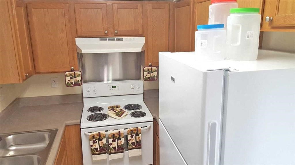 a kitchen with a stove and a refrigerator