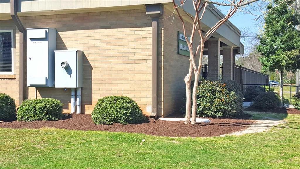 a brick building with a tree in front of it