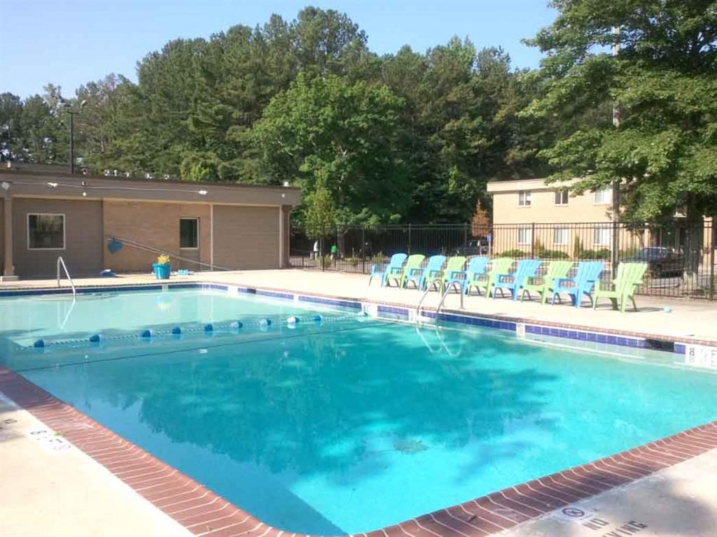 a large swimming pool with chairs around it