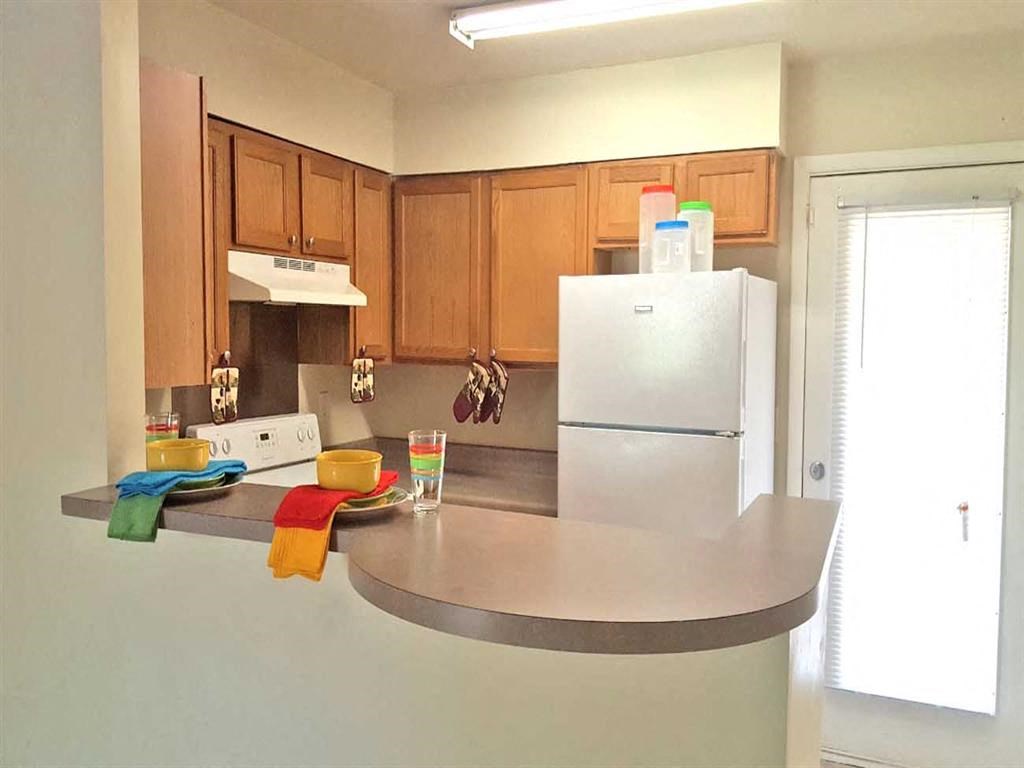 a kitchen with a white refrigerator and a counter top