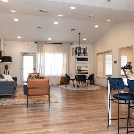 a living room and dining room with a table and chairs