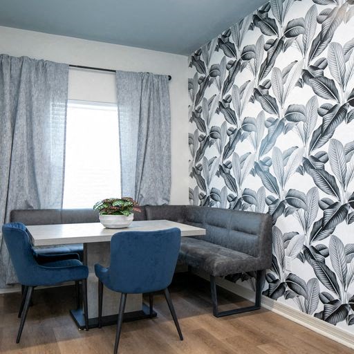 a dining room with a table and chairs and a window