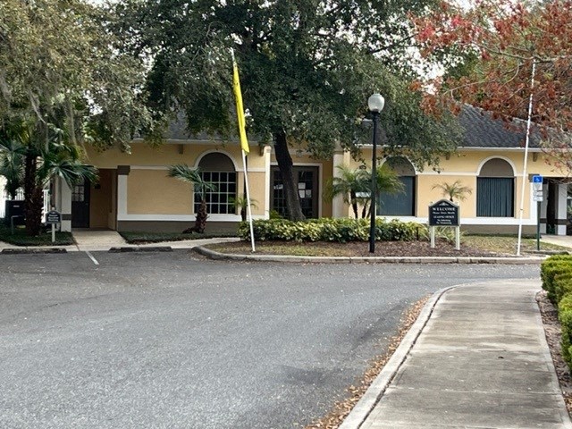 a yellow building with a street in front of it