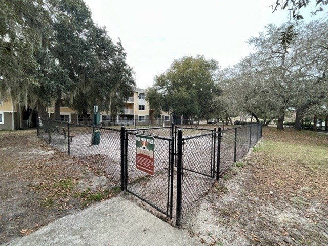 a fence with a sign on it in a park