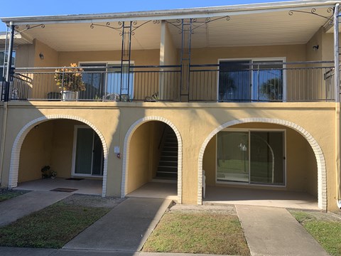 an apartment building with arches and a balcony