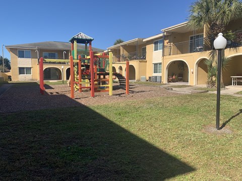 a playground in a yard in front of a building